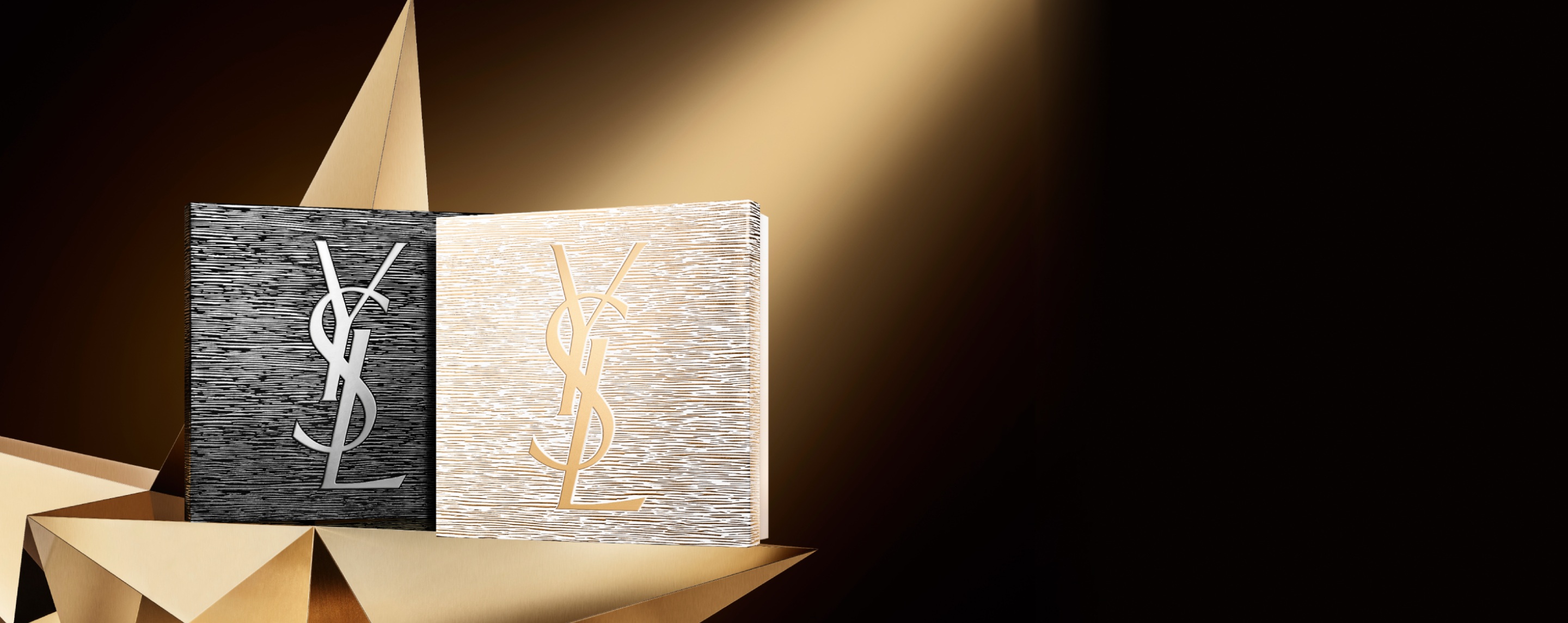 Holiday gift sets in black and gold with YSL Beauty logo, displayed on a golden star with a dark background.